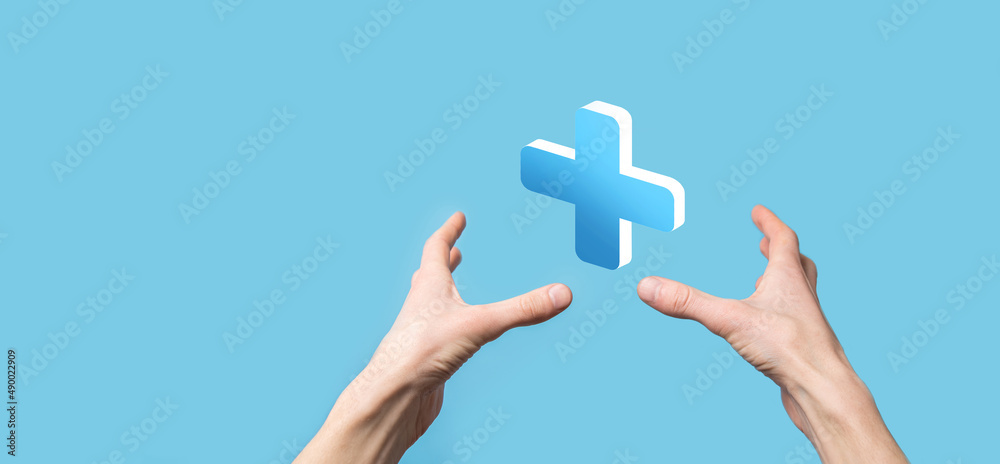 Businessman hold 3D plus icon, man hold in hand offer positive thing such as profit, benefits, development, CSR represented by plus sign.The hand shows the plus sign