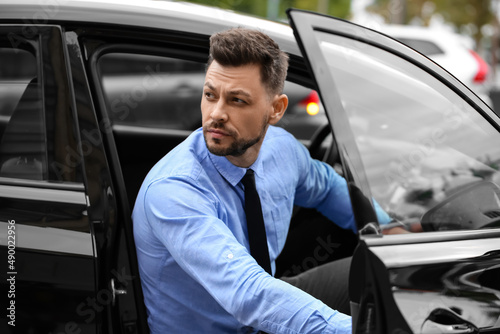 Handsome businessman sitting in modern car © Pixel-Shot