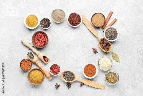 Frame made of aromatic spices on light background