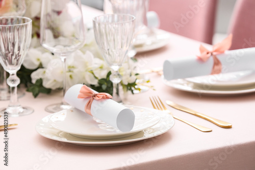 Stylish table setting with wedding invitations