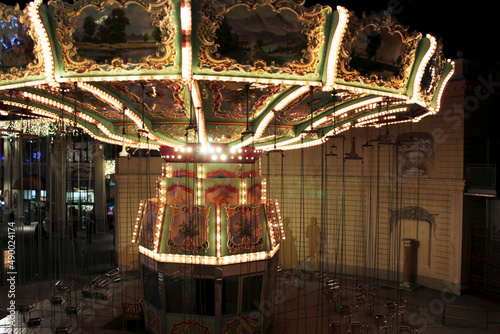 A lighted up beautiful inoperative carousel at night. photo
