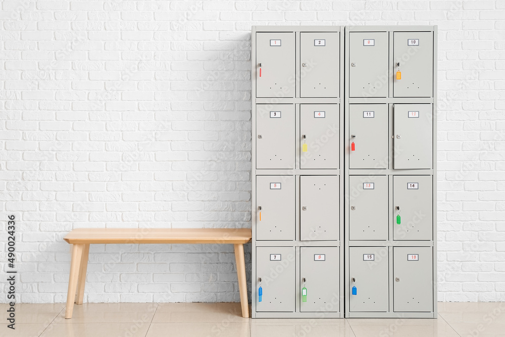 Modern locker and bench near white wall Stock Photo | Adobe Stock