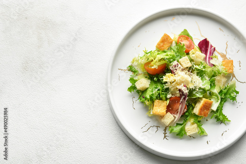 Plate of tasty vegan Caesar salad on white background, closeup