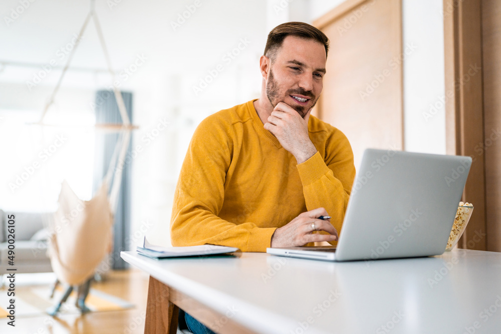 Man working at home on laptop computer Man working at home on laptop computer