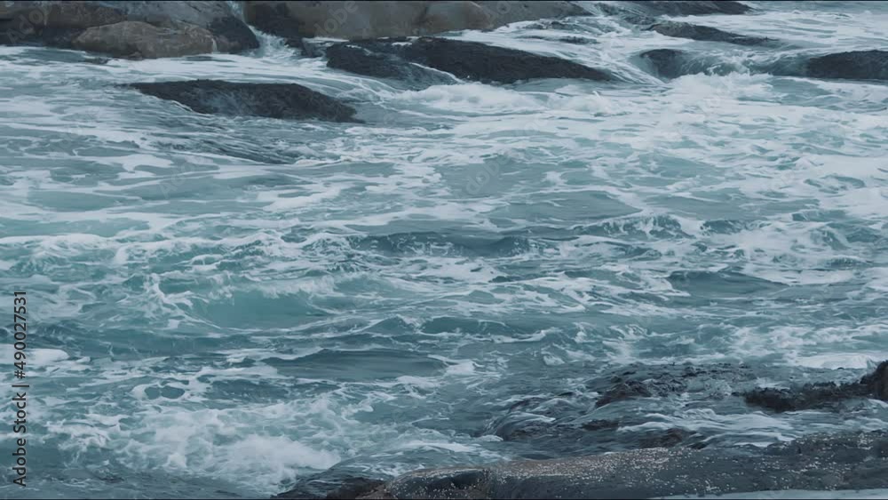 Fascinating view of the sea waves breaking on the rocky shore and whirlpools between the stones. Slow motion Fascinating view of the sea waves breaking on the rocky shore and whirlpools between the stones. Slow motion