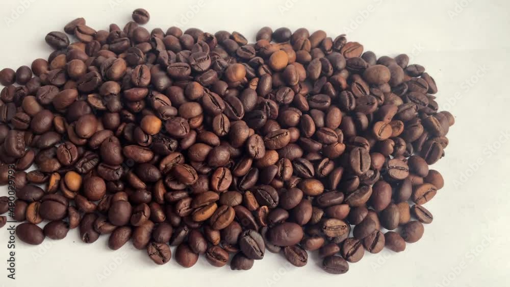 Camera movement around coffee beans.Coffee beans against white background. Camera movement around coffee beans.Coffee beans against white background.