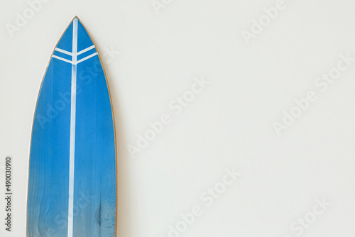 Blue surfboard near light wall