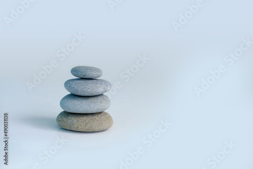 Tower  stack of pebbles in an unstable state  pyramid made of flat stones on a gray background  concept tourist walk in nature  harmony and balance  zen in life  nature conservation