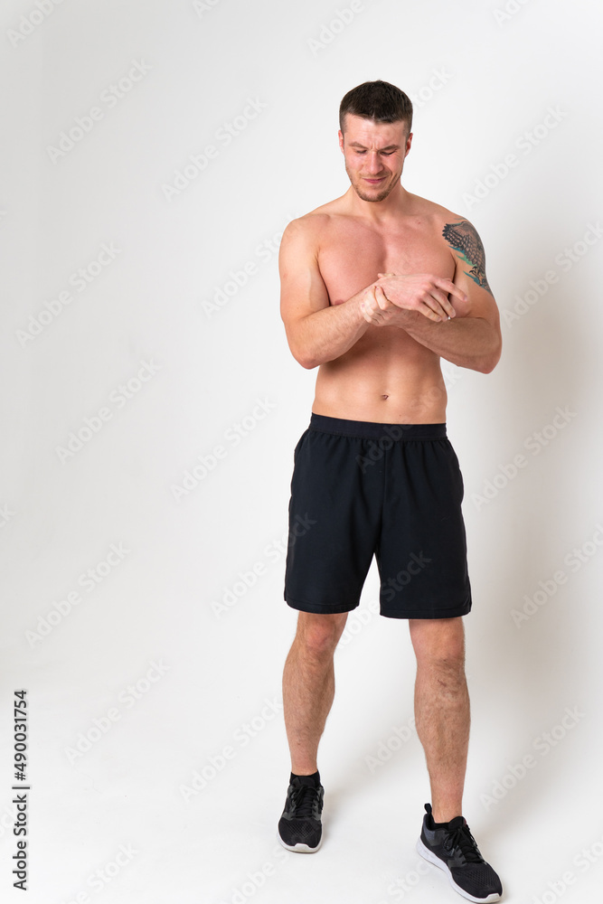Muscles on the arm ache in a man on a white background back muscle, backache spine caucasian young medicine, holding. Tension neck sickness, back suffer attractive Muscles on the arm ache in a man on a white background back muscle, backache spine caucasian young medicine, holding. Tension neck sickness, back suffer attractive