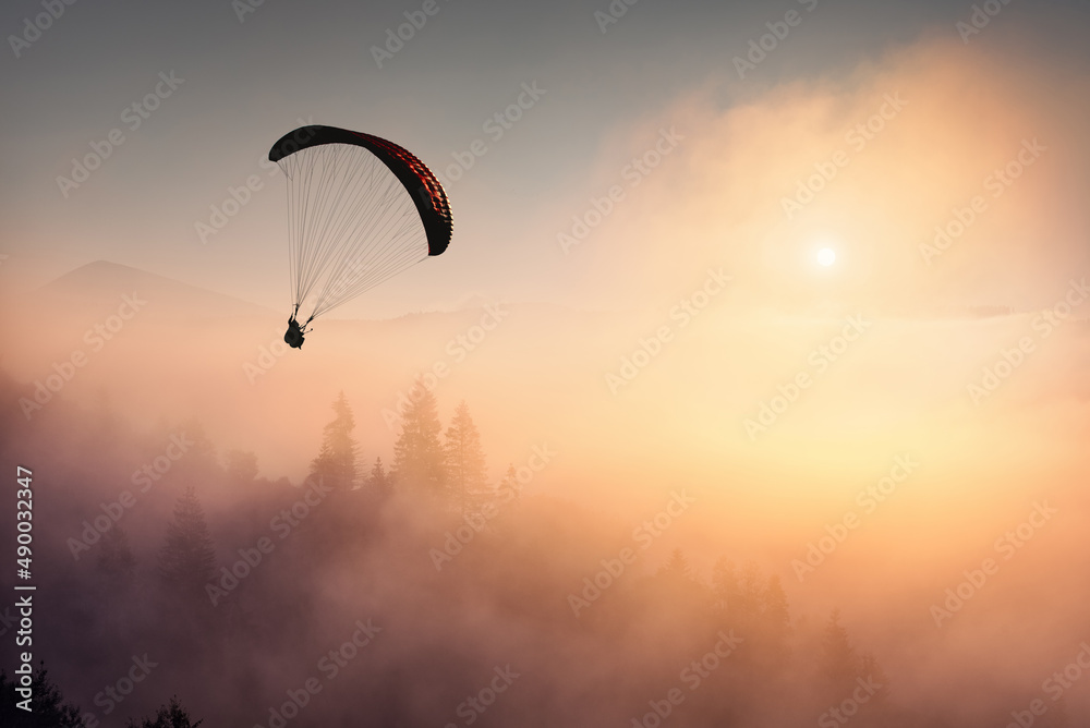 Paraglide silhouette over free ukrainian Carpathians Paraglide silhouette over free ukrainian Carpathians