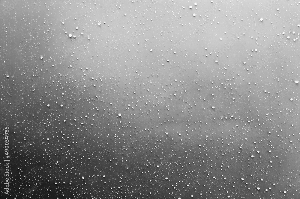 Drops of dew on a gray surface.