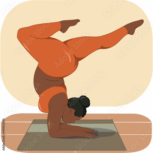 A large, elegant, black girl does yoga in an orange suit