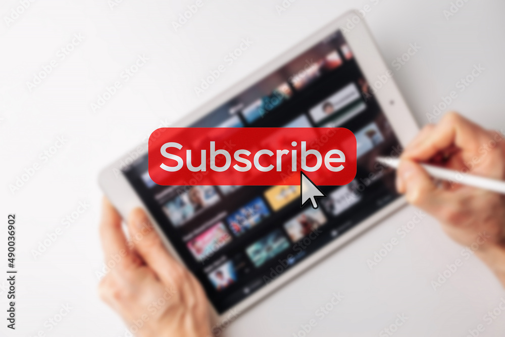 Subscription plan. Red online video subscribe button. Internet service on laptop digital tablet blured technology background. Visual contents concept. Social networking service. Subscription plan. Red online video subscribe button. Internet service on laptop digital tablet blured technology background. Visual contents concept. Social networking service.