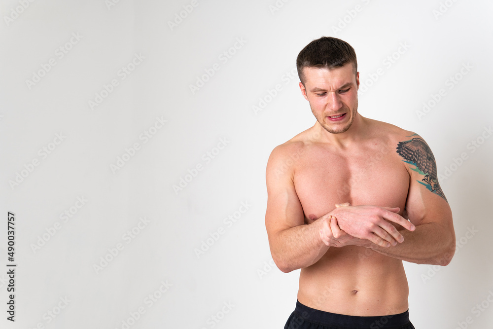Muscles on the arm ache in a man on a white background back sore injury, male background human chronic. Touching lumbar sickness, disease suffer attractive Muscles on the arm ache in a man on a white background back sore injury, male background human chronic. Touching lumbar sickness, disease suffer attractive