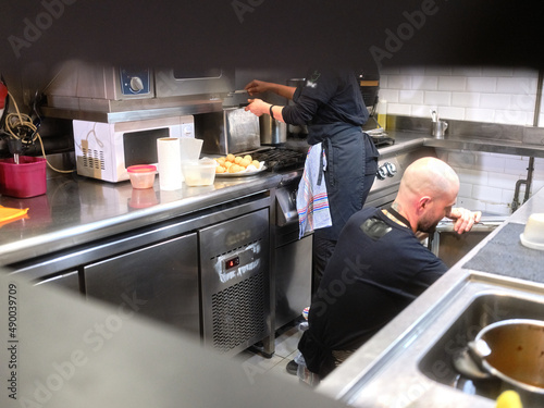 Two person working on the kitchen of a restaurant
