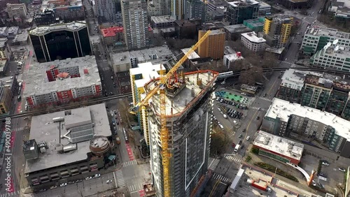Rising aerial shot of a skyscraper under construction near Amazon's downtown headquarters in Seattle, WA.