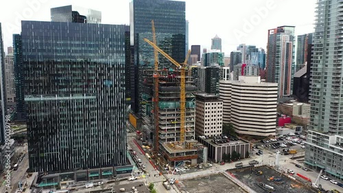 Construction cranes building a skyscraper in Seattle's South Lake Union neighborhood.