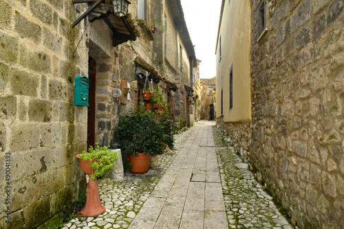 Fototapeta Naklejka Na Ścianę i Meble -  A narrow street among the old stone houses of the oldest district of the city of Caserta Vecchia, Italy.