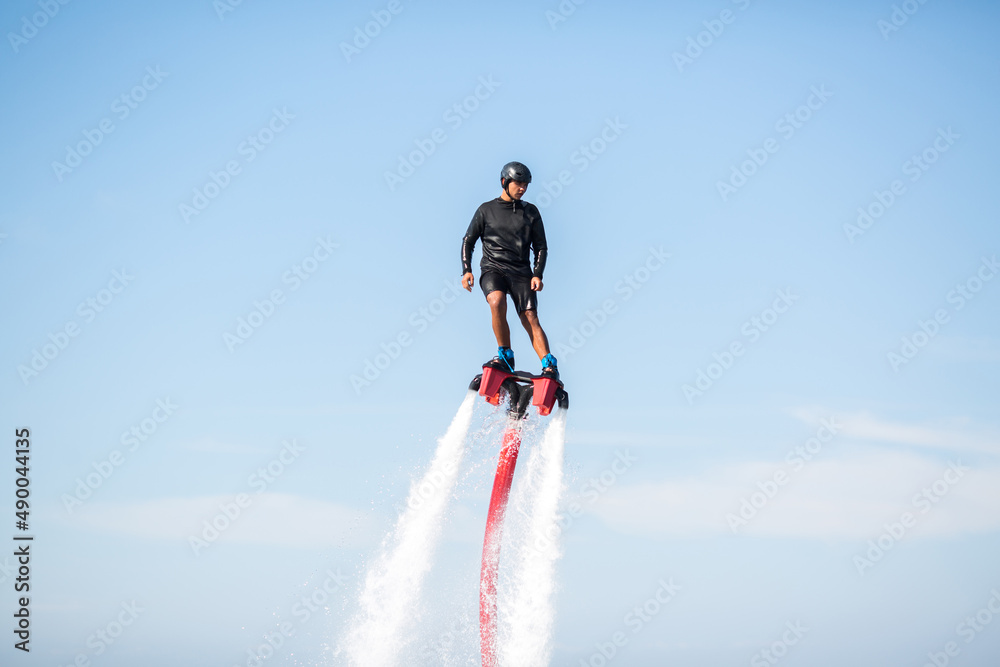 Silhouette of a fly board rider at sea Silhouette of a fly board rider at sea