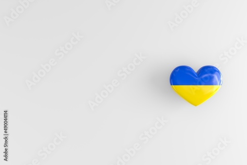 Fotografiet Flag of Ukraine on a heart-shaped badge as a symbol of love for one's homeland