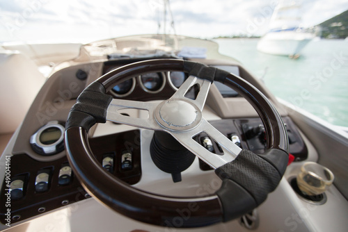 Instrument panel and steering wheel of a motor boat cockpit (yacht control bridge) © Artem Zakharov