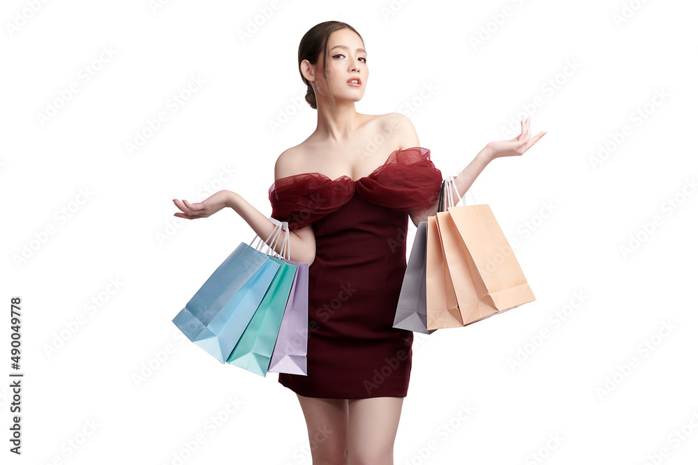Asian Women are shopping, Beautiful young asian woman with red dress holding shopping bags isolated on white background. Asian Women are shopping, Beautiful young asian woman with red dress holding shopping bags isolated on white background.