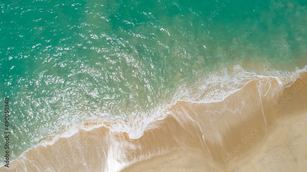 Aerial view sandy beach and crashing waves on sandy shore Beautiful tropical sea in the morning summer season image by Aerial view drone shot, high angle view Top down