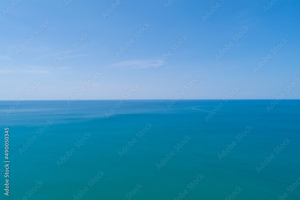 Aerial view of a blue sea surface water texture background and sun reflections Aerial flying drone view Waves water surface texture on sunny tropical ocean in Phuket island Thailand