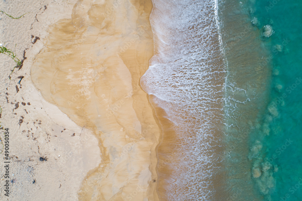 Aerial view sandy beach and crashing waves on sandy shore Beautiful tropical sea in the morning summer season image by Aerial view drone shot, high angle view Top down Aerial view sandy beach and crashing waves on sandy shore Beautiful tropical sea in the morning summer season image by Aerial view drone shot, high angle view Top down