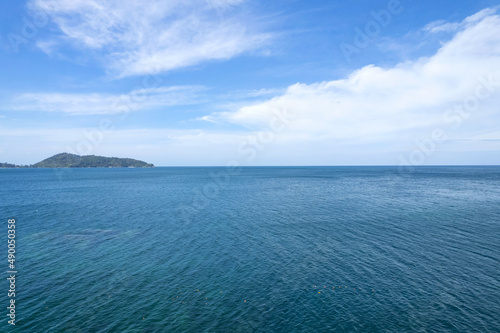 Aerial view of a blue sea surface water texture background and sky white clouds Aerial flying drone view Waves water surface texture on sunny tropical ocean in Phuket island Thailand