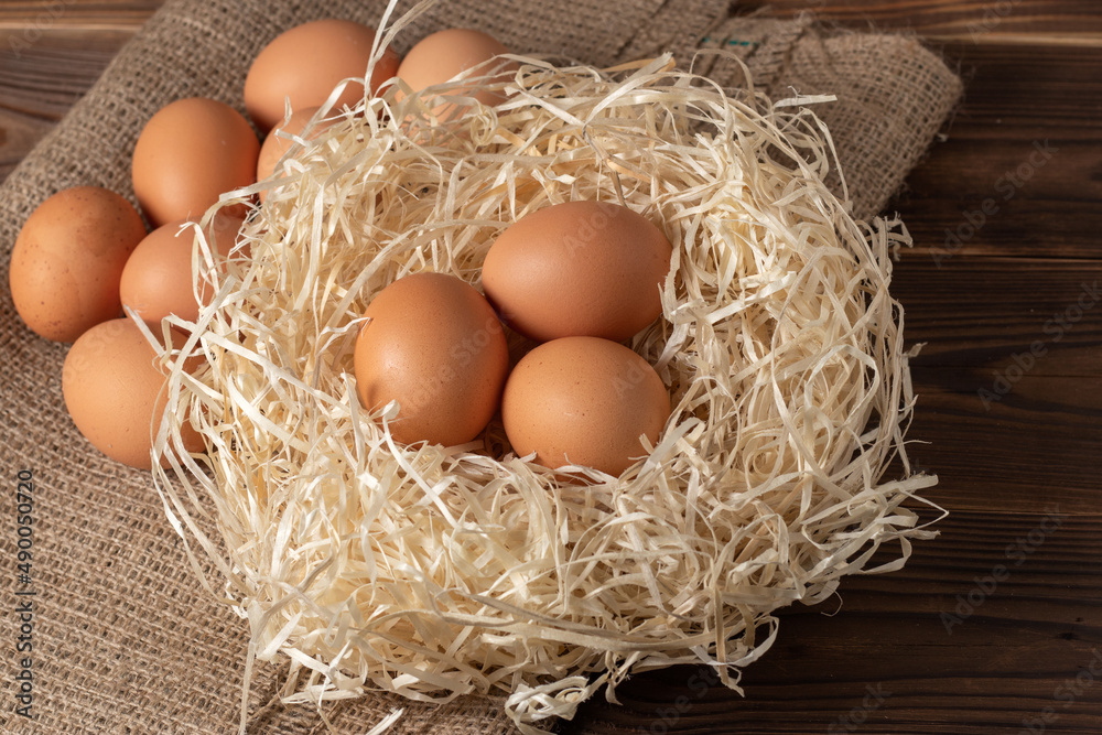 Hay with eggs on wooden background. Hay with eggs on wooden background.