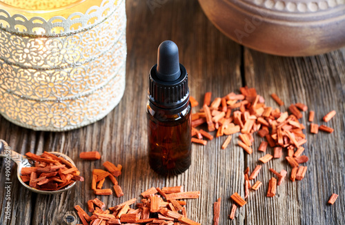 Canvas-taulu A cropper bottle of sandalwood essential oil with red sandalwood