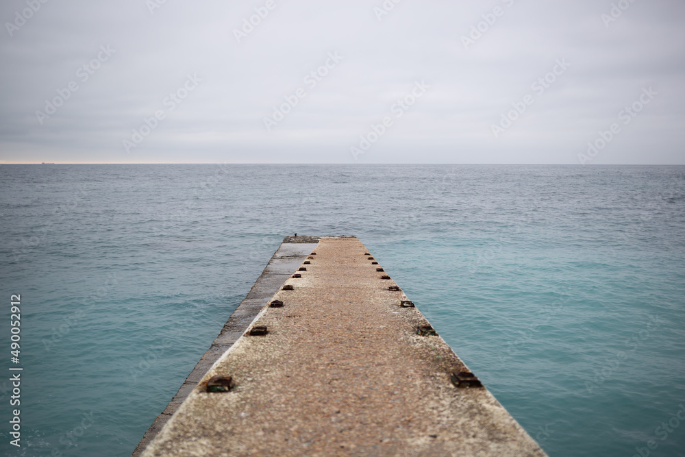 a pier that splits into two at the end and goes out to sea.
