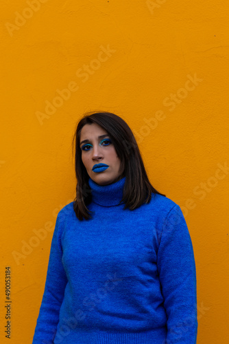 portrait of serious woman on yellow background