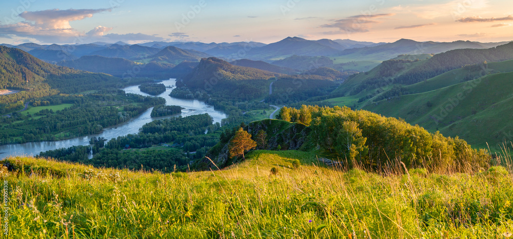 View of the valley and the Katun River from the mountain. Spring view, evening light.