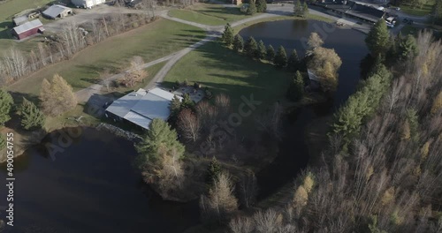 Drone aerial clip of a beautiful acreage property with a large pond and a bunch of old buildings in Ottawa region (Bean Town Ranch). photo