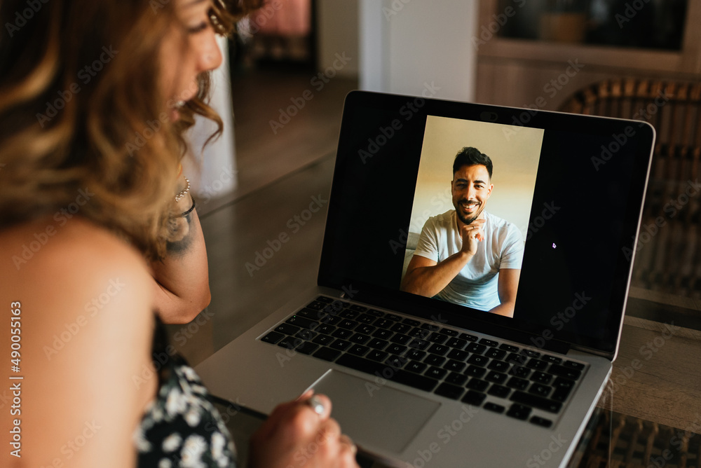 Woman having a video call on a laptop computer at home. Technology, communication and new normal lifestyle concept. Woman having a video call on a laptop computer at home. Technology, communication and new normal lifestyle concept.
