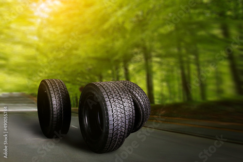 Change a car seasonal tire summer forest road with trees background. Change for winter tire. Banner Selling off. Or Background automechanic  © Katarina