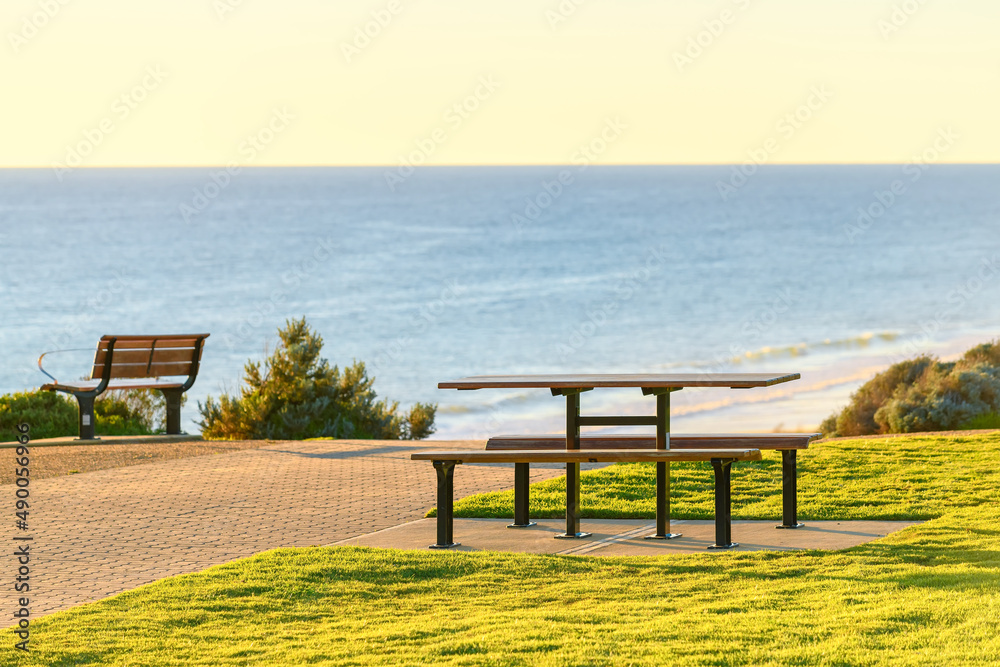 Picnic table at Maslin Beach sea shore at sunset, South Australia Picnic table at Maslin Beach sea shore at sunset, South Australia