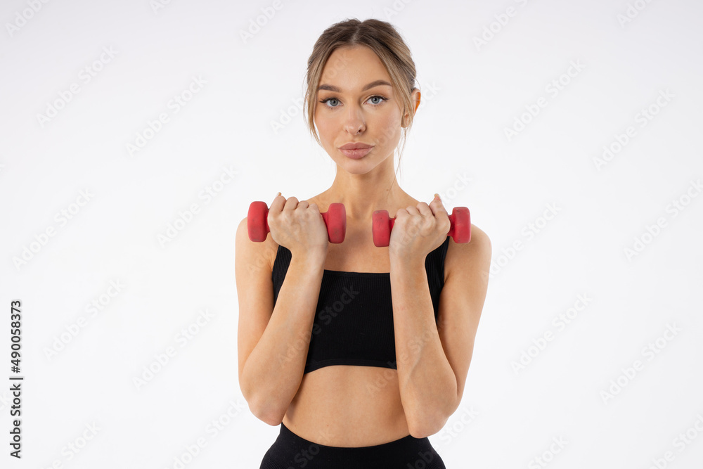 thin young female doing gymnastics with dumbbells thin young female doing gymnastics with dumbbells