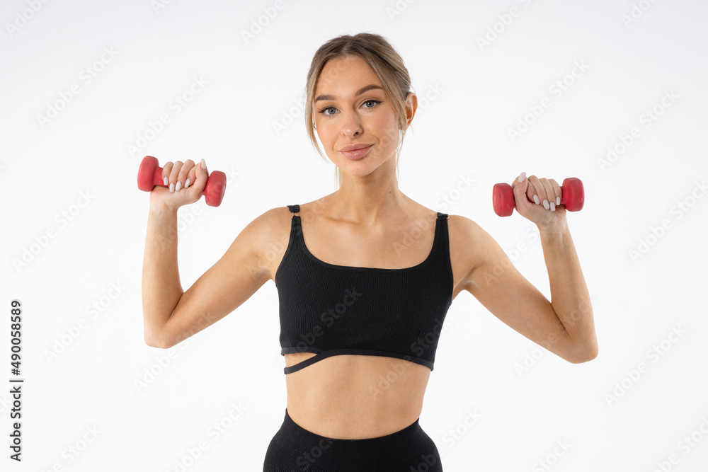 training with dumbbells of a beautiful young female on a white background training with dumbbells of a beautiful young female on a white background
