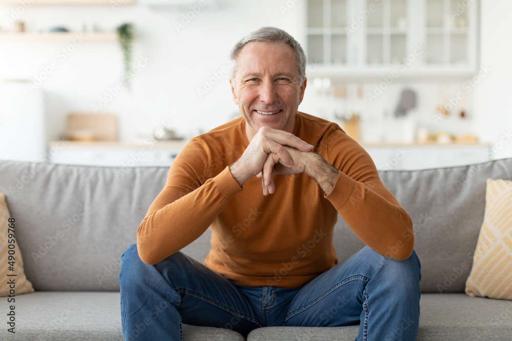 Mature man having rest at home on the couch