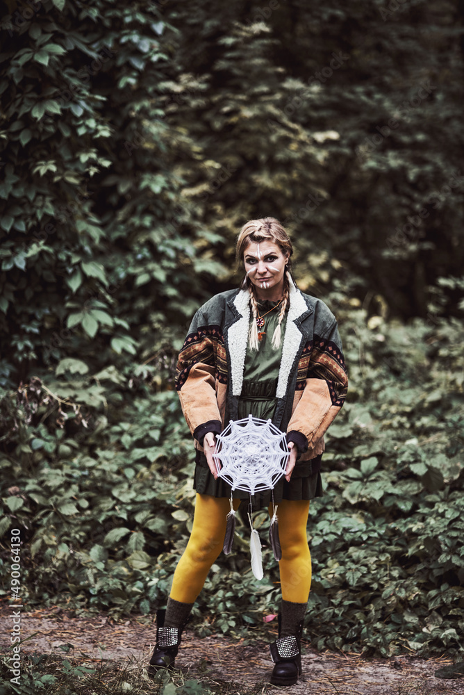 Photo of a girl dressed as a national American. Walk and rest in the summer forest. Entertainment. The game. Fun. Wear a jacket, khaki dress and bright yellow tights. Happy woman.