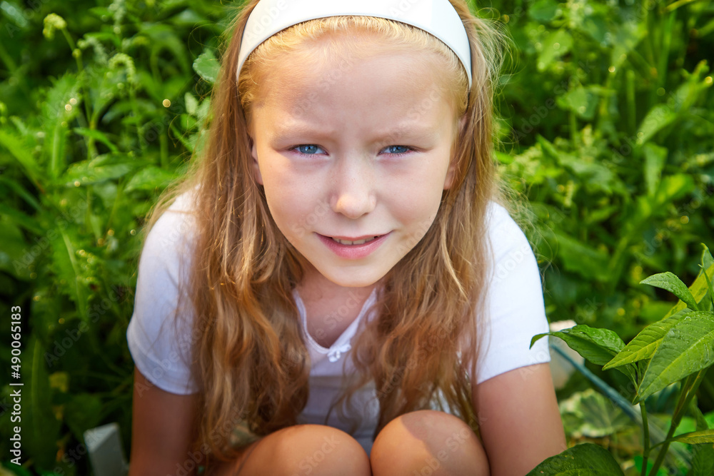 Sad blonde girl in nature in green grass in a summer day Sad blonde girl in nature in green grass in a summer day