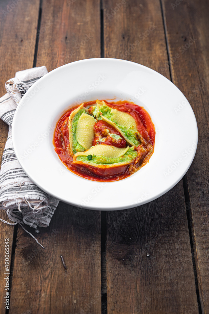 pasta stuffed spinach cheese conchiglie stuffing garnish healthy meal food snack on the table copy space food background pasta stuffed spinach cheese conchiglie stuffing garnish healthy meal food snack on the table copy space food background