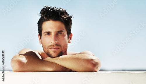 Summer thoughts. Portrait of a good-looking male staring at you relaxing on a summers day - Copyspace. photo