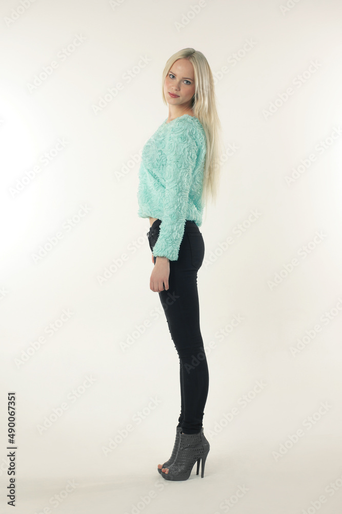 Sometimes casual is fashionable. A young model in trendy clothing posing against a white background. Sometimes casual is fashionable. A young model in trendy clothing posing against a white background.