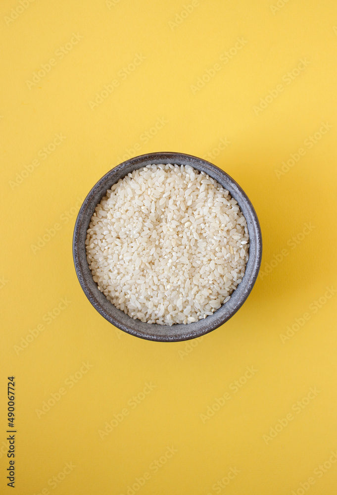 grey bowl with rice on background with copy space for your text, top view. Natural food high in protein grey bowl with rice on background with copy space for your text, top view. Natural food high in protein