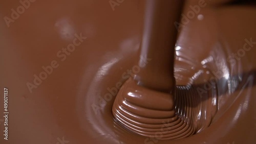Close-up stirring chocolate, hot melted liquid chocolate.