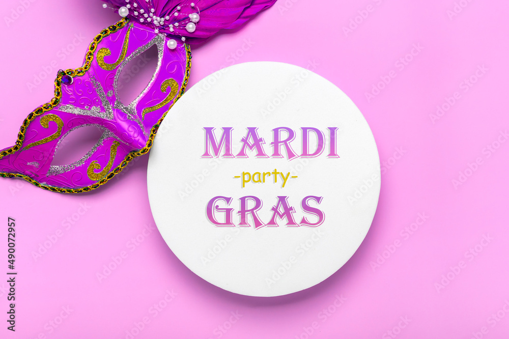 Mardi gras lettering. Congratulation card with mask on white podium on violet background Top view 2022 Mardi Gras Parade Schedule